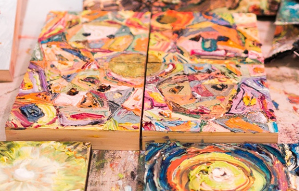 close up to artwork on a table, swirls of paint on wood blocks